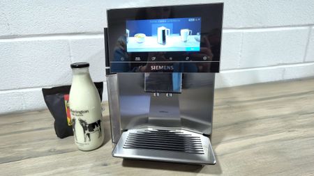 Siemens EQ900 Plus coffee maker with coffee beans and milk bottle