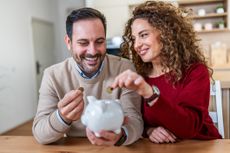 a happy couple saving money