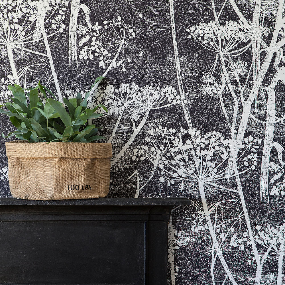 bedroom with cole and son paper and plant