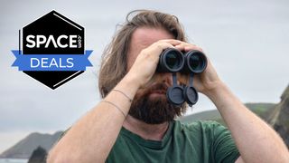 A male looking through the Nikon Monarch M7 8x42 binoculars with a grey sky in the background and a black Space.com deals badge in the upper left corner.