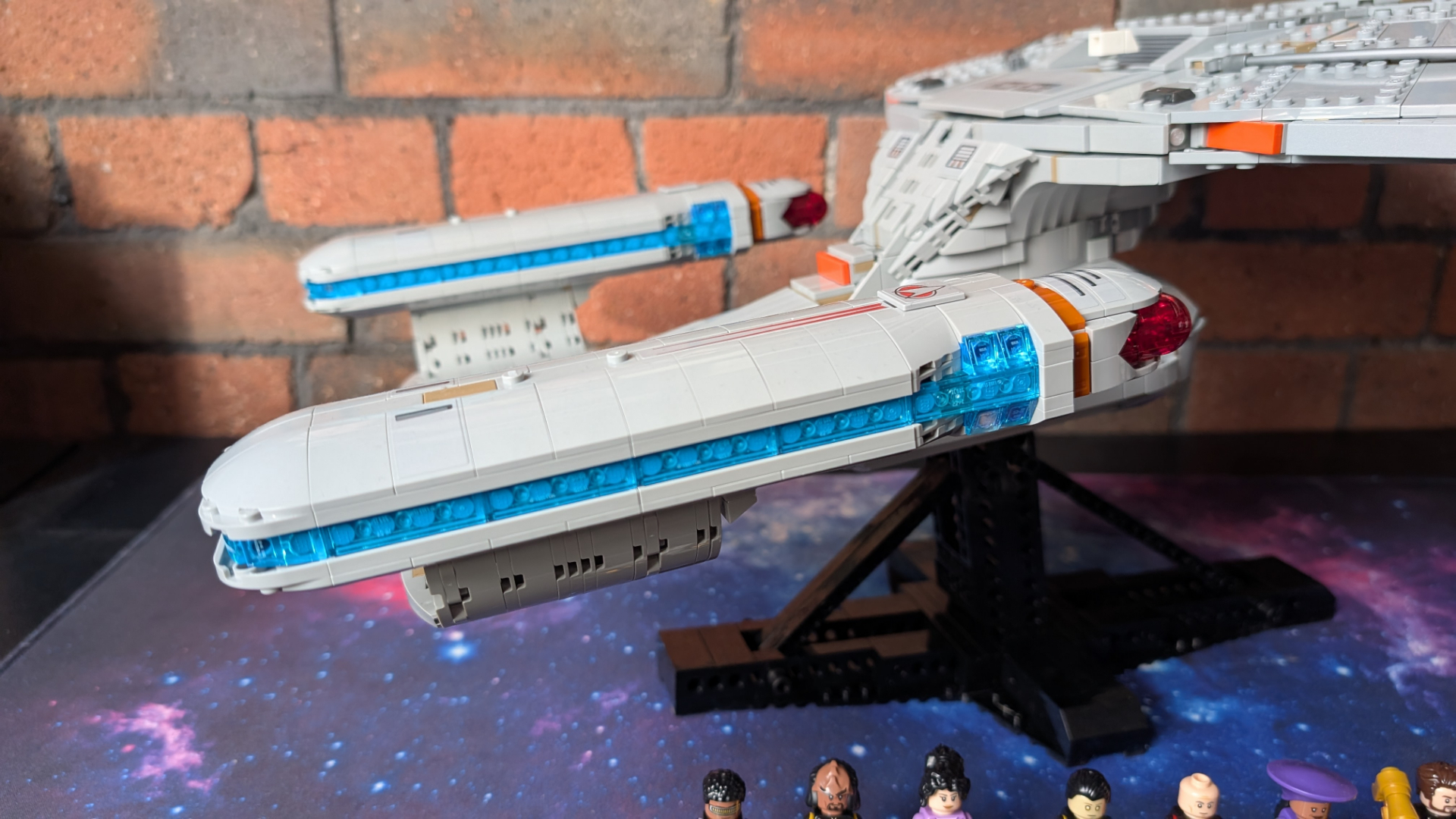 Lego U.S.S. Enterprise set on stand, with the engines seen from the side