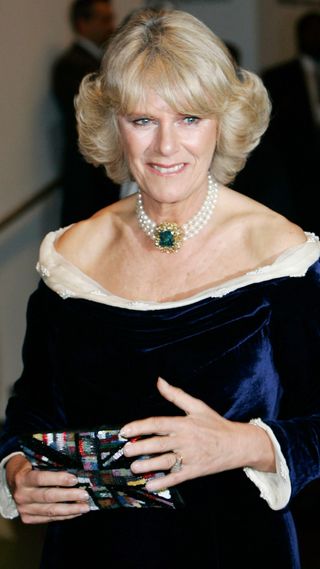 Queen Camilla in a navy gown while on her first overseas tour as a royal