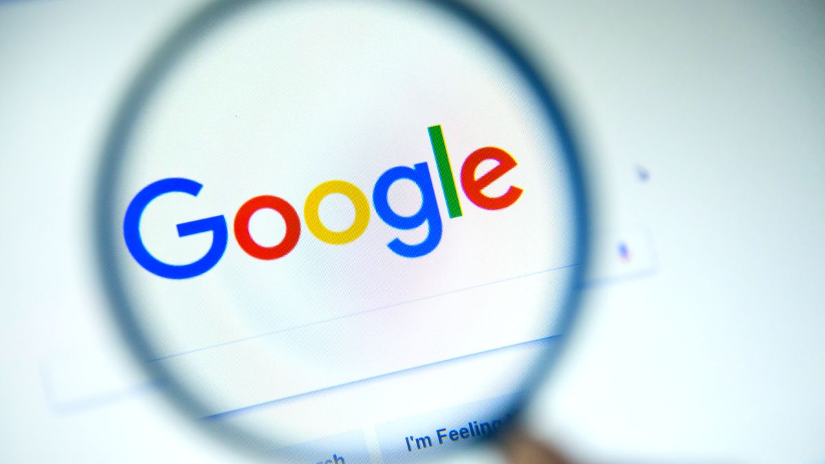 The Google logo under a magnifying glass