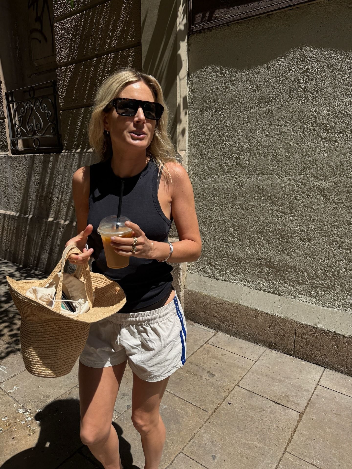 Lucy Williams wearing a black tank and white boxer shorts