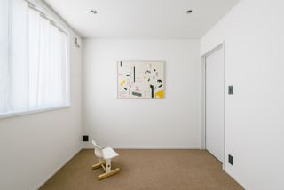 bedroom interior with clean white walls at House in Tamatsukuri