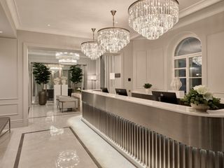 Lobby desk and art deco-style chandeliers at The Hotel Maria Helsinki