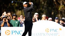 Tiger Woods takes a tee shot in a pro-am ahead of the PNC Championship