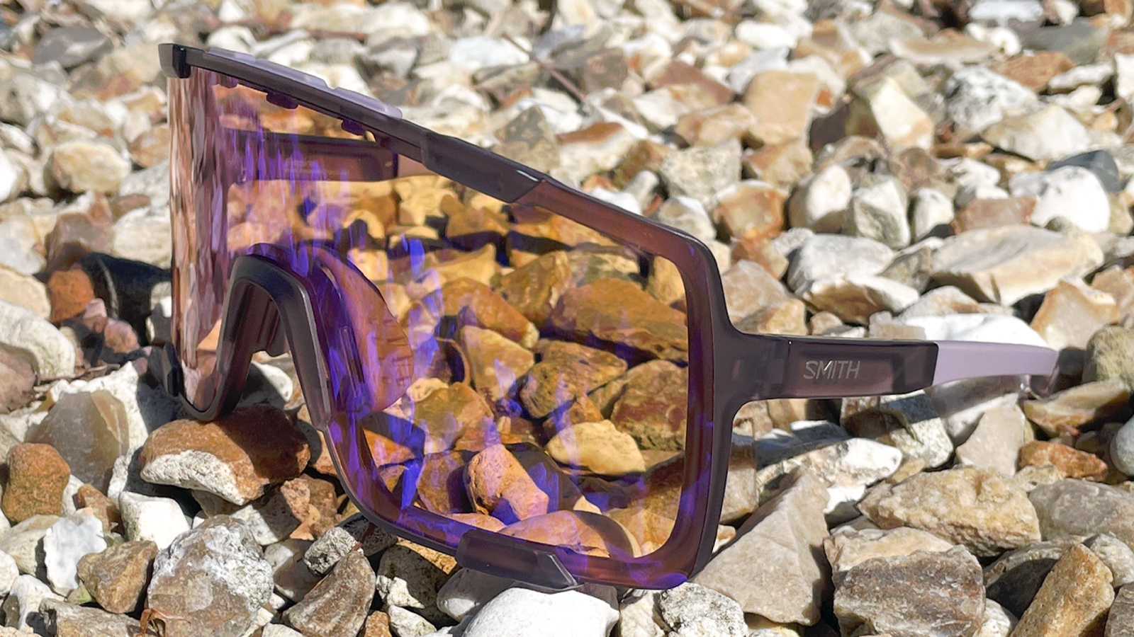 A pair of Smith Syncline glasses on some gravel