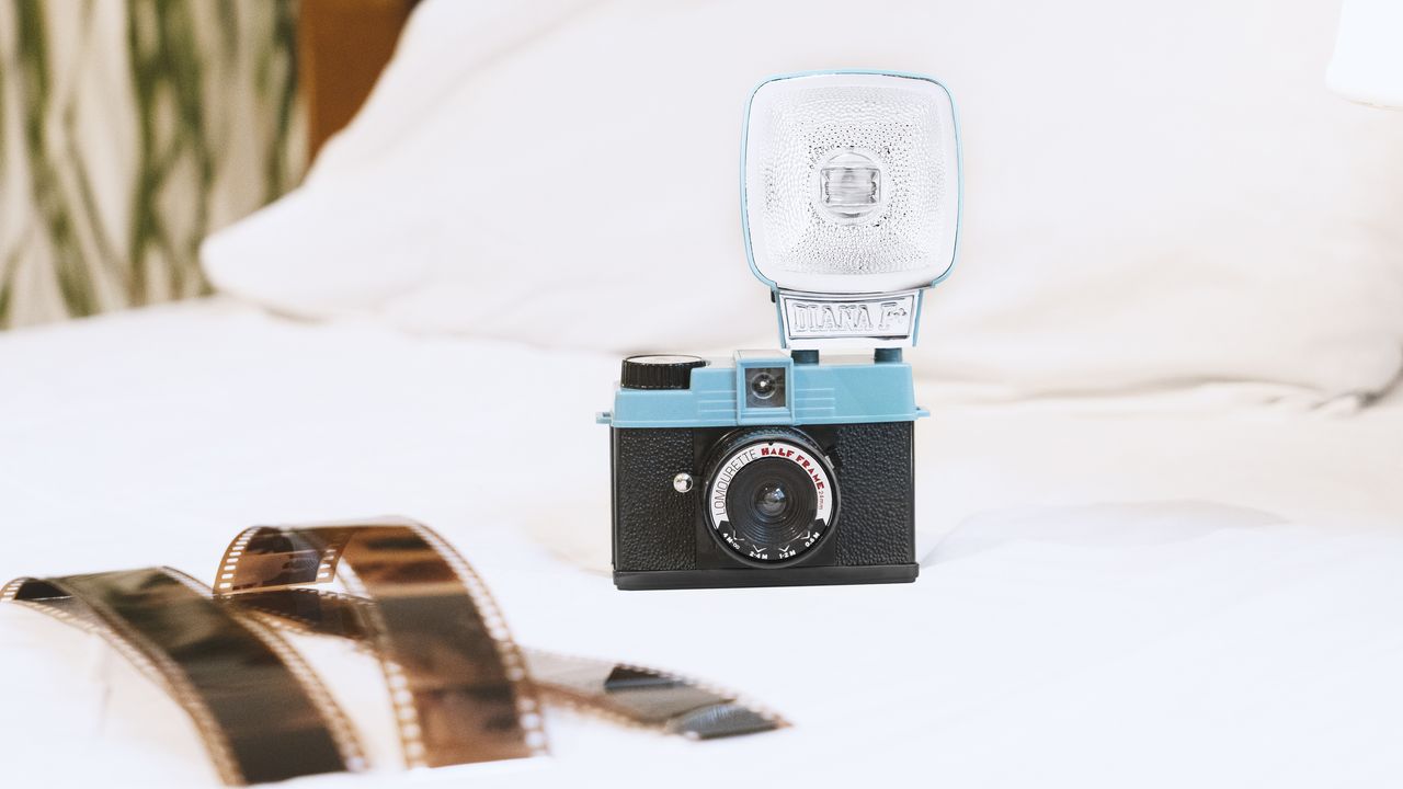 The Lomography Half-Frame Lomourette lifestyle image on a bed with film