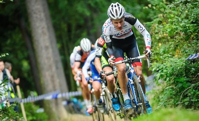 Lubomir Petrus (BKCP-Powerplus) leading the chase group on a climp in the woods in Lostice