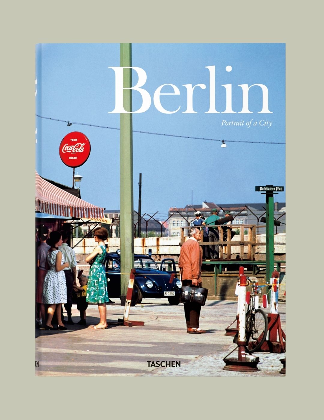 A book cover, featuring a road station cafe, reads "Berlin. Portrait of a City" in white.