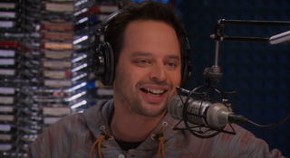 Nick Kroll wearing headphones on Parks and Recreation.