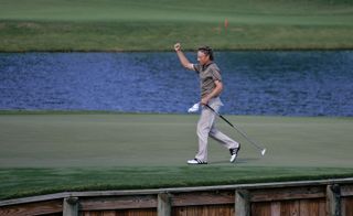 Bernhard Langer celebrates holing a putt on the 17th at TPC Sawgrass