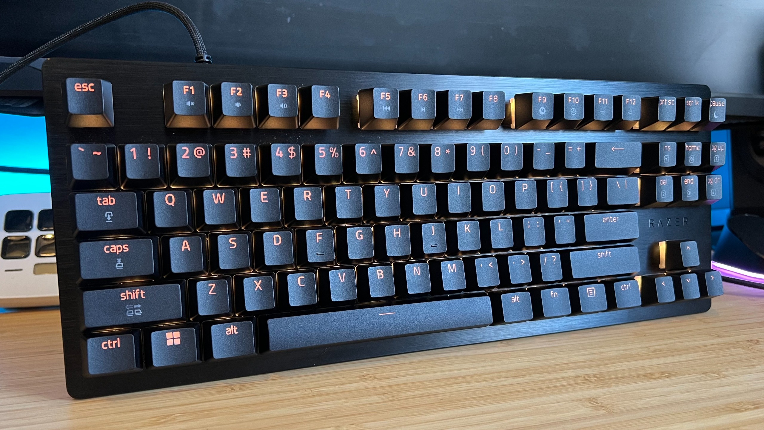 Razer Huntsman V3 HE TKL keyboard on a wooden desk 