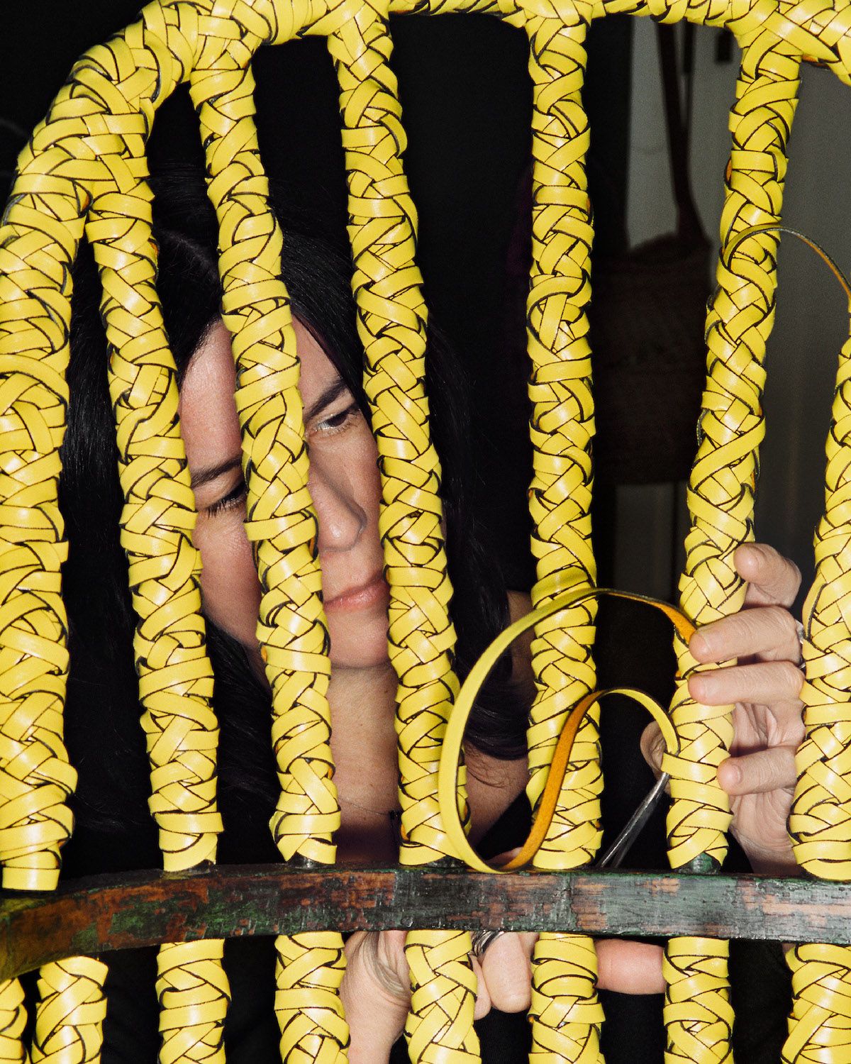 An artisan works on a Loewe chair