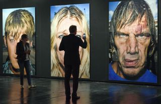 A man looks at portrait photos from Bruce Gilden can be seen in the exhibit Masters of Photography at the photokina in Cologne, Germany, 20 September 2016