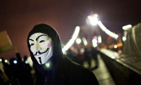 A masked Occupy Wall Street protester walks across the Brooklyn Bridge Thursday night: Hundreds of Occupiers were arrested during the two-month-old movement&amp;#039;s &amp;quot;Day of Action.&amp;quot;