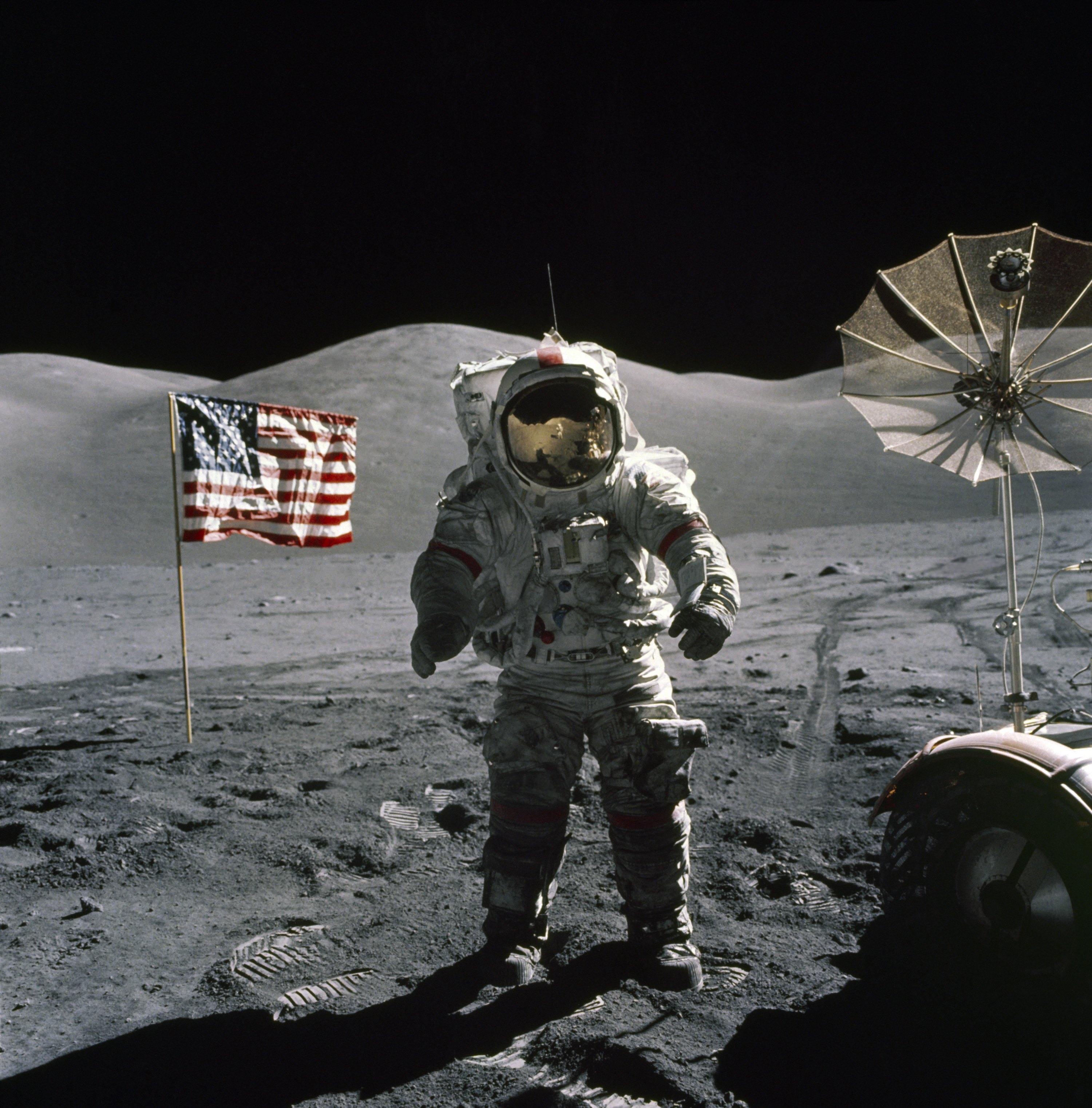 Apollo 17 commander Eugene A. Cernan stands next to the American flag on the moon.