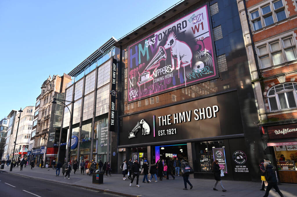 Front of a HMV shop with people walking outside