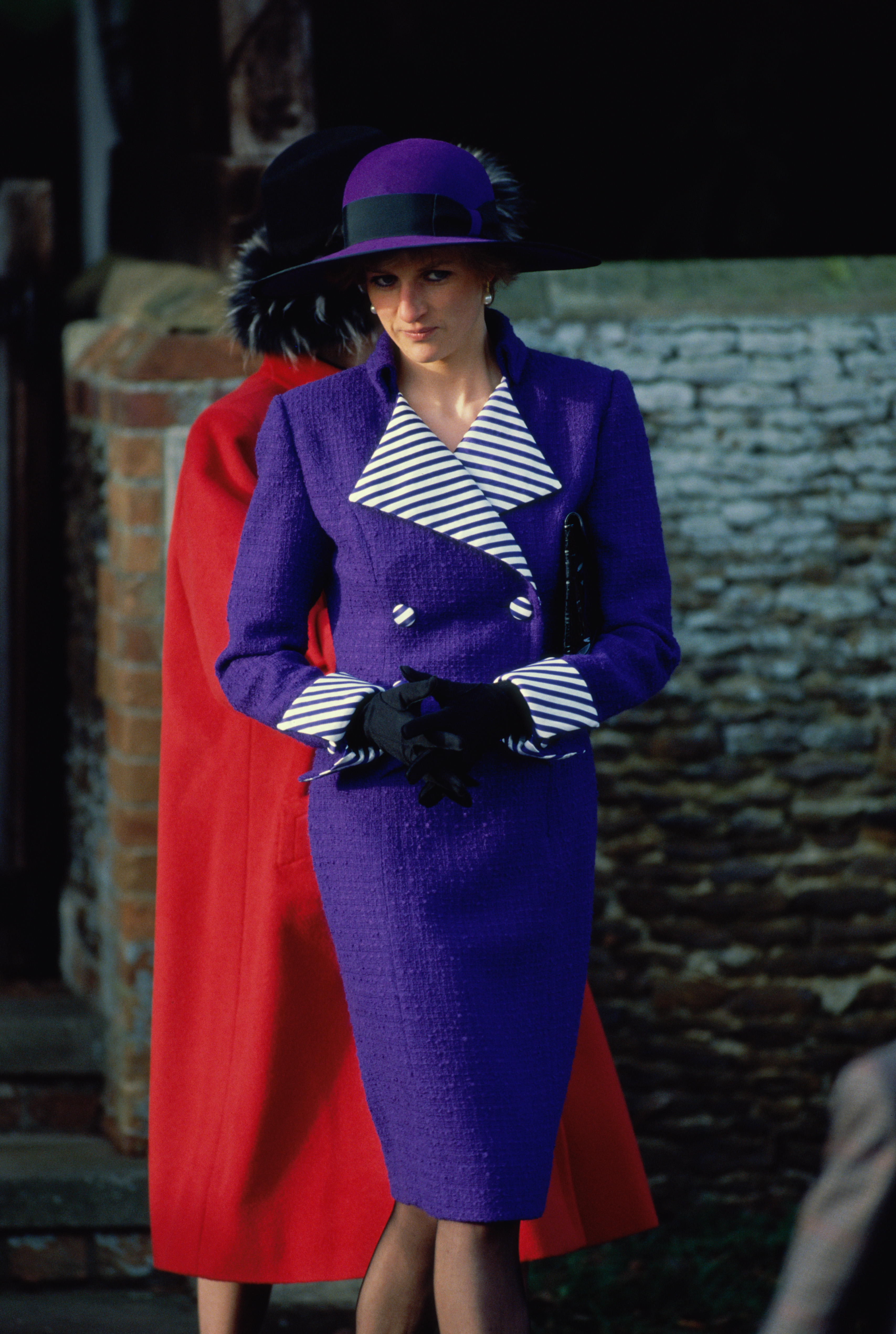 Princess Diana wearing a purple suit and hat at Sandringham on Christmas Day 1990