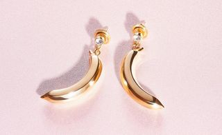 e a pair of bananas hanging from diamond earring studs by Prada