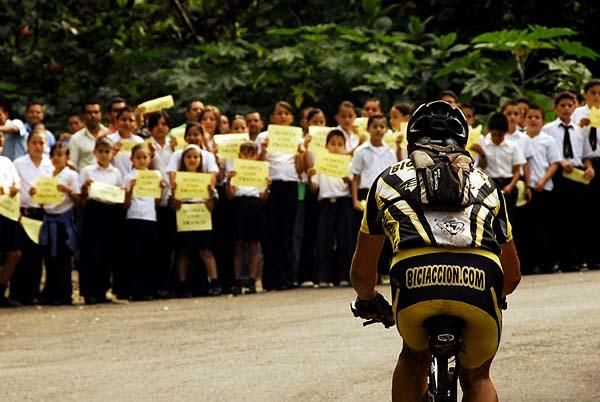 Children at local schools cheer the racers along the route during stage 2.