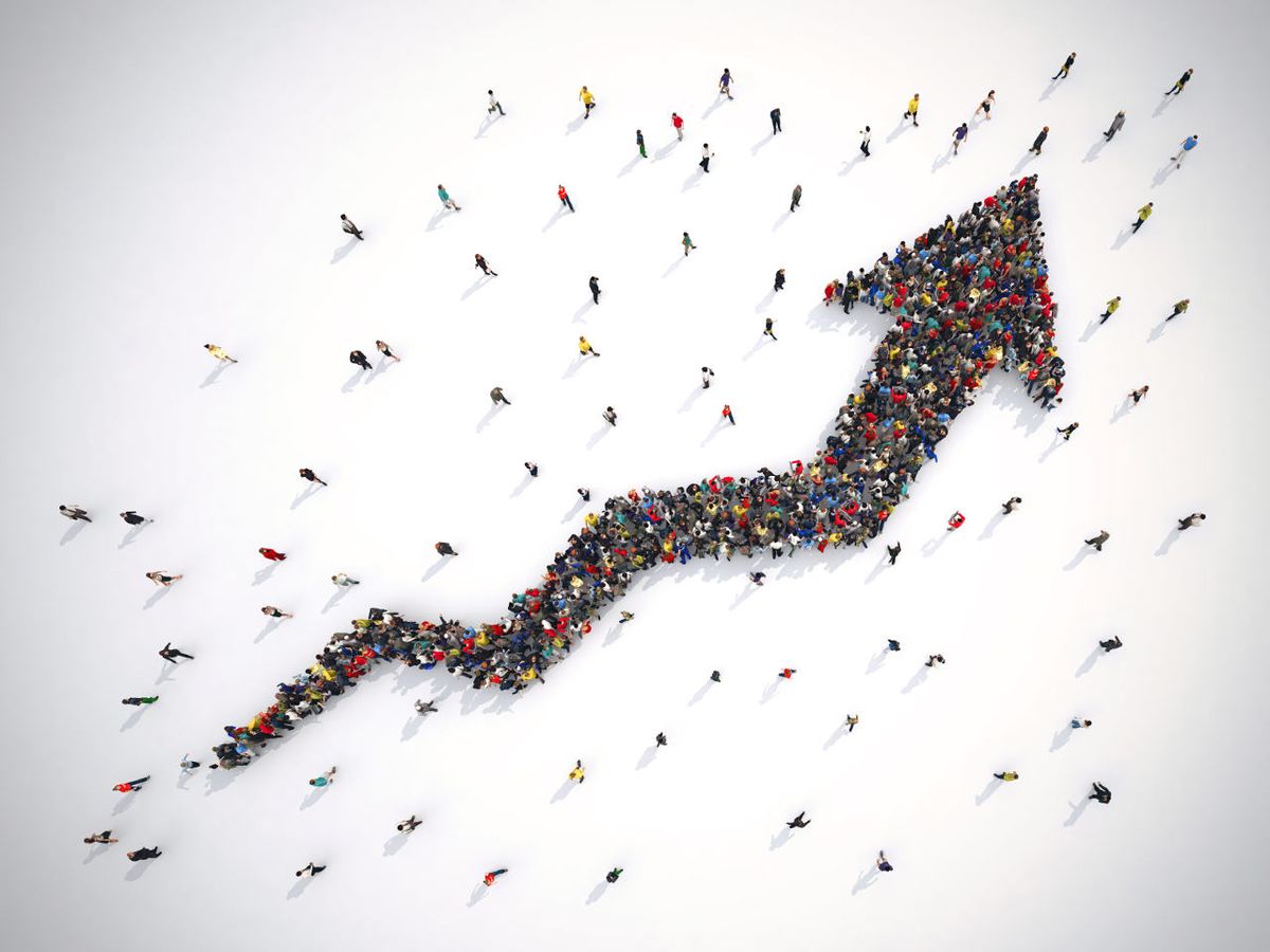 Crowds of people form an arrow going upwards