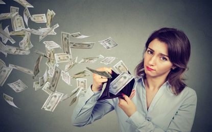 Sad woman showing her wallet with money dollar banknotes flying out away