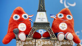 A replica of the Eiffel Tower with the logo of the 2024 Olympic Games surrounded by official mascots for the Paris 2024 Summer Olympic and Paralympic Games 