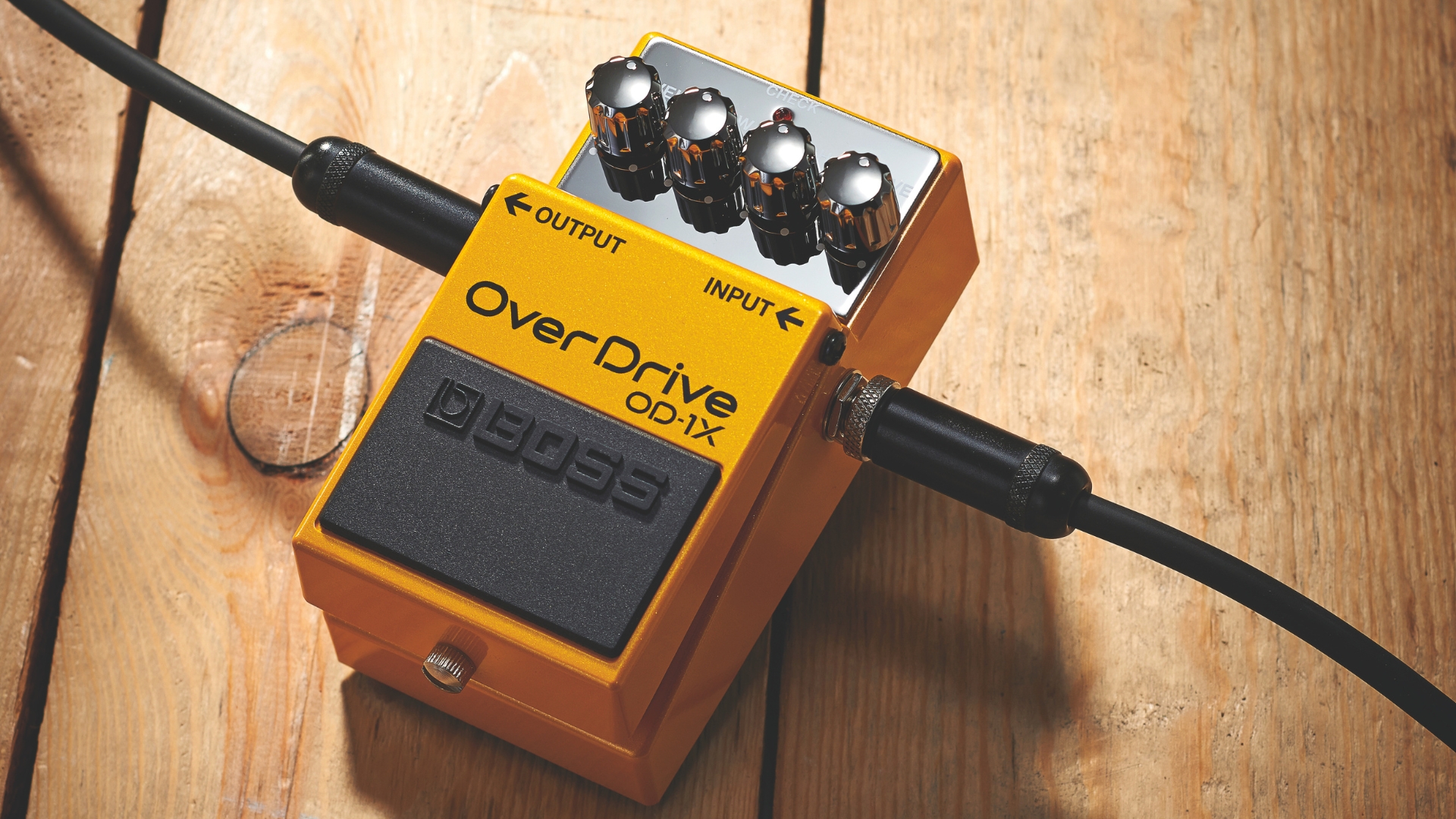 A Boss Overdrive OD-1X on a wooden floor