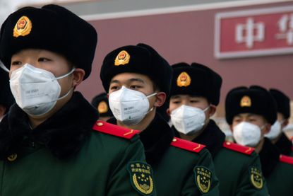 Officers in China wear masks