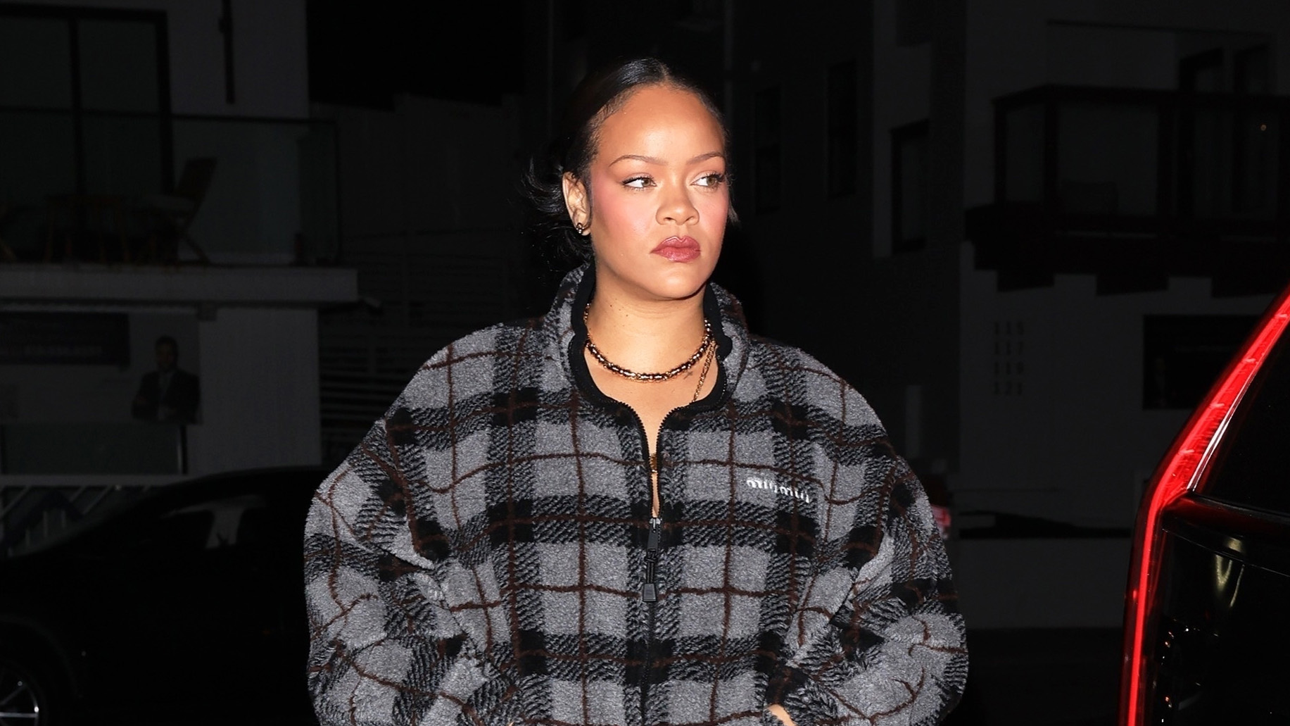 Rihanna wearing the Miu Miu Checked Teddy Jacket with track pants and snakeskin boots