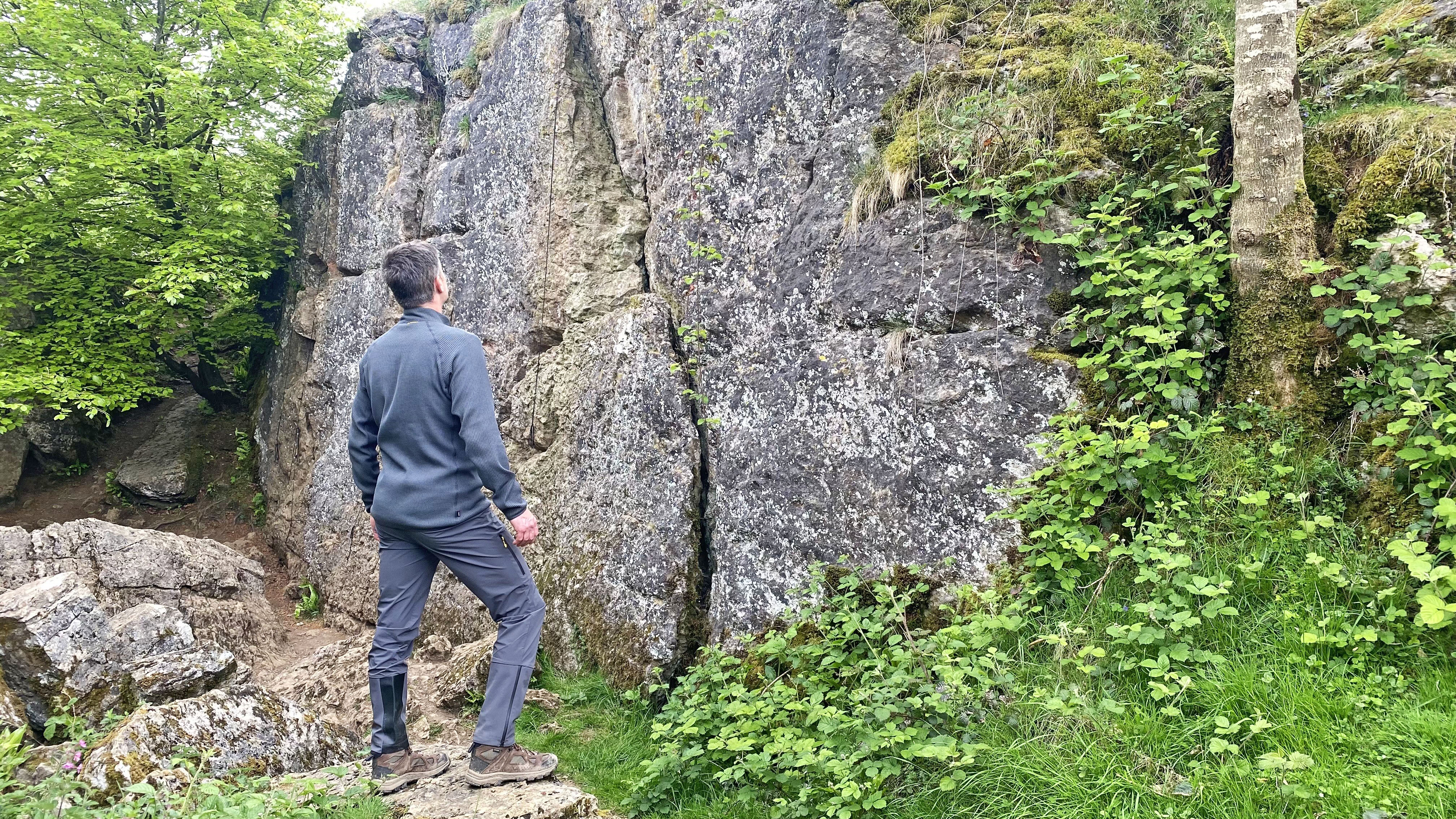Man in Haglofs LIM Flex pants eyes up a bouldering problem