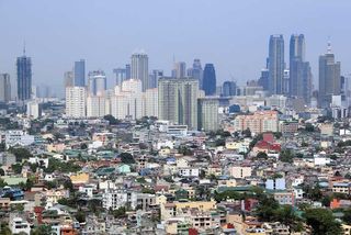 Densley populated housing developments crowding high rise condominium ad commercial districts in ortigas and makati manila the philippines.