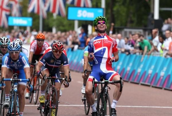 Mark Cavendish (Great Britain) celebrates as he beats Sacha Modolo (Italy) and Samuel Dumoulin (France) to win the London-Surrey Classic road race