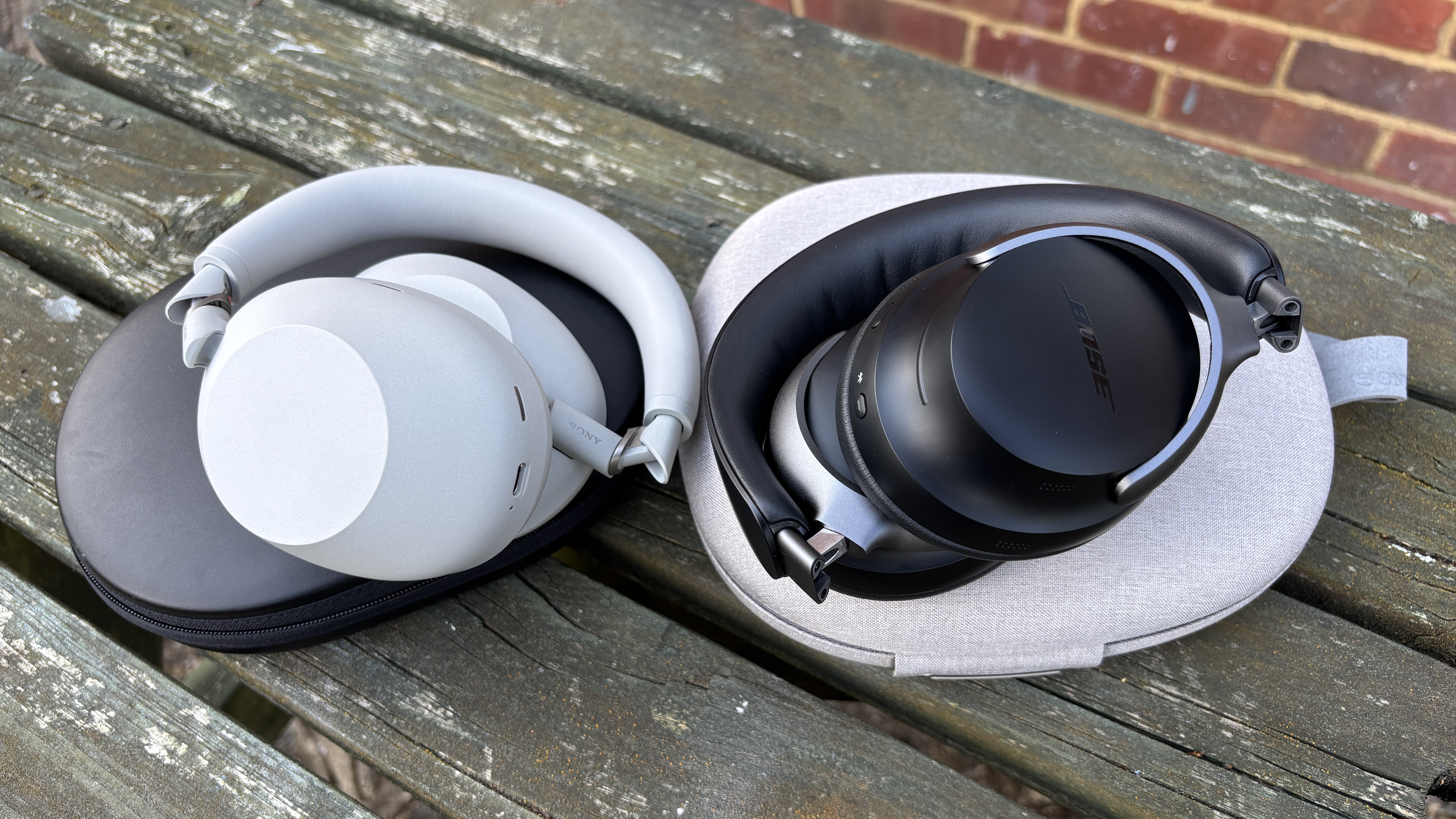 Sony WH-1000XM6 and Bose QuietComfort Ultra Headphones folded up on their cases
