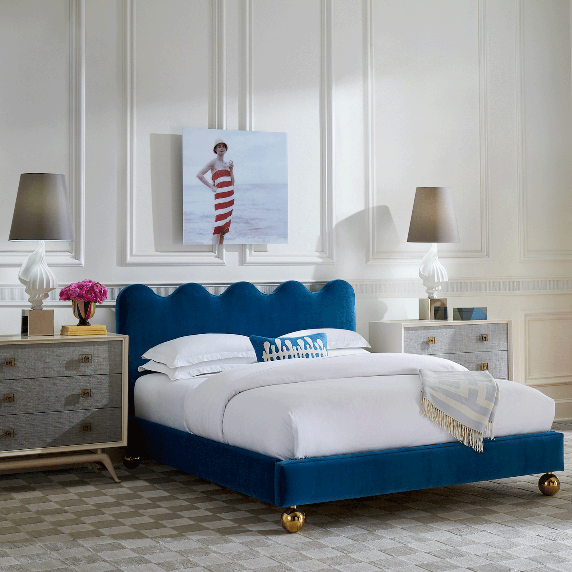 Neutral bedroom with navy blue upholstered bed with scalloped headboard