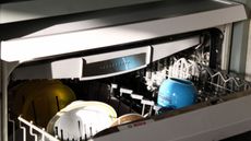A partially open dishwasher in a kitchen