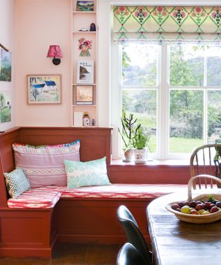 Banquette seating upholstered in antique textiles