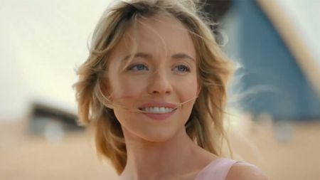 Sydney Sweeney with her hair blowing in the wind outside Sydney opera house, AU. 