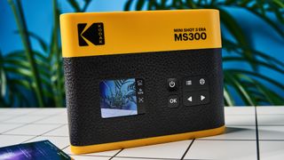 A black and yellow Kodak Mini Shot 3 Era 2-in-1 instant camera and printer