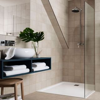 bathroom with white tiled walls and shower
