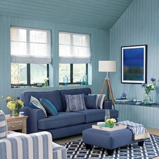 Blye living room with wall panelling and matching sofa and ottoman