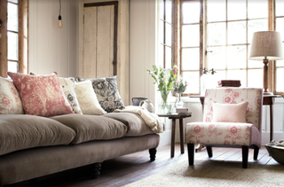 farmhouse style living room with botanical print cushions, velvet sofa and armchair