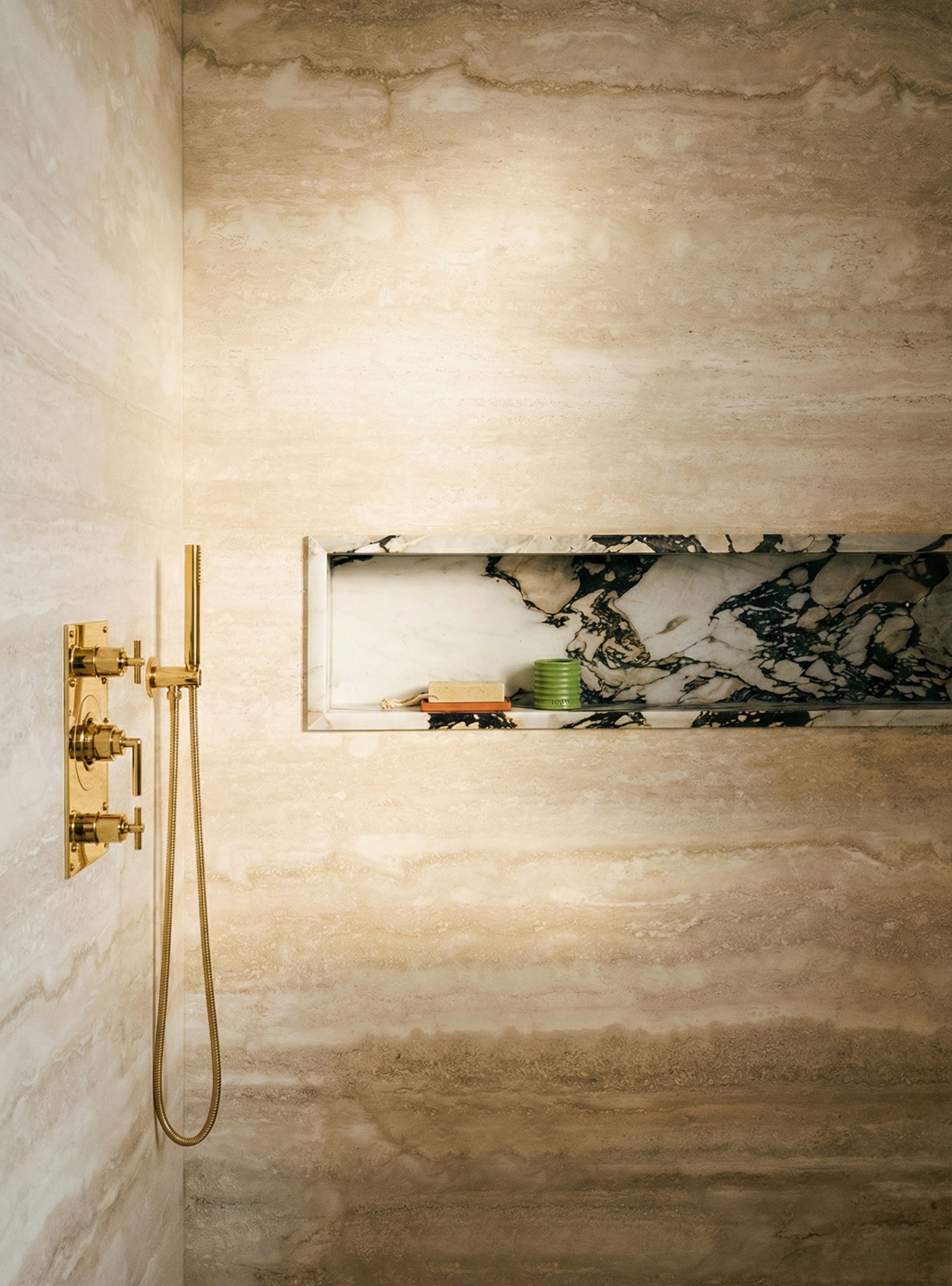 Statement recessed niche in shower with marble finish