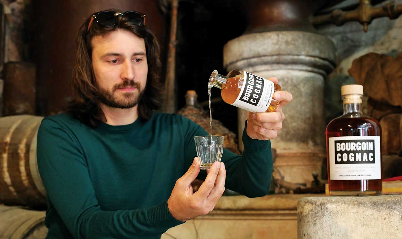 Fr&amp;eacute;d&amp;eacute;ric Bourgoin pouring his estate's Cognac into a glass