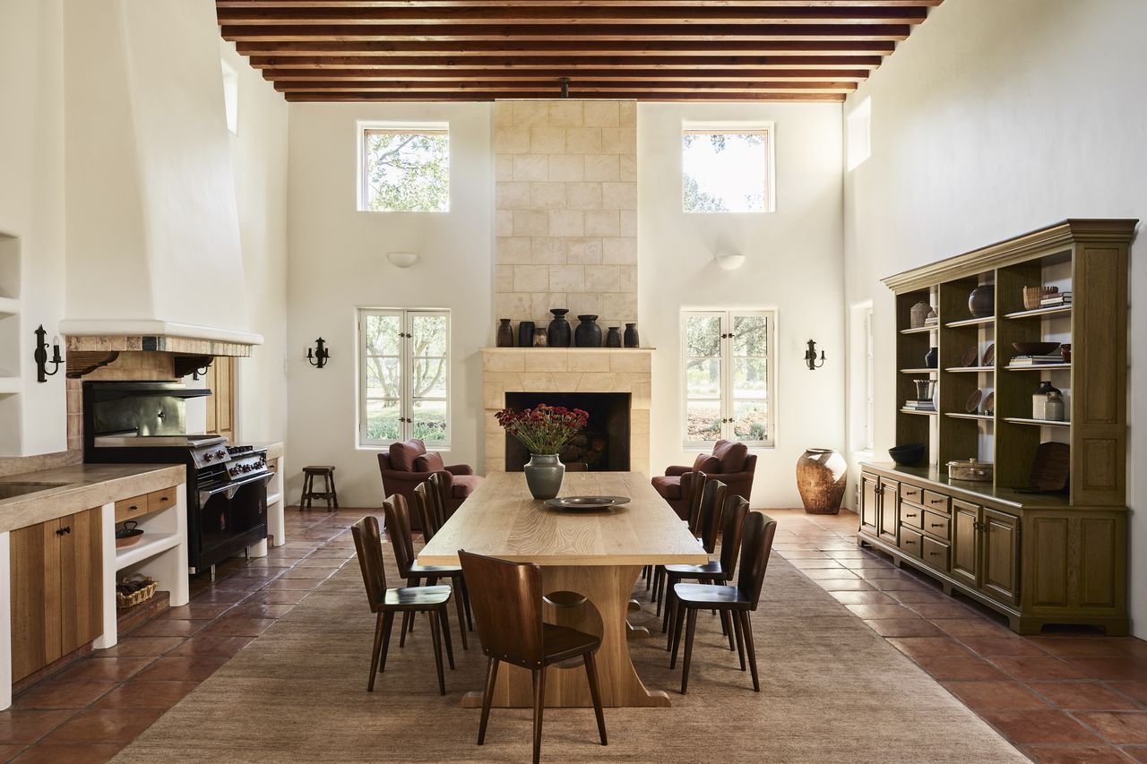 A dining room with windows without curtains