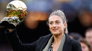 Alexia Putellas lifts her Ballon d'Or Feminin trophy on the pitch prior to the La Liga Santander match between FC Barcelona and Real Betis at Camp Nou on December 04, 2021 in Barcelona, Spain
