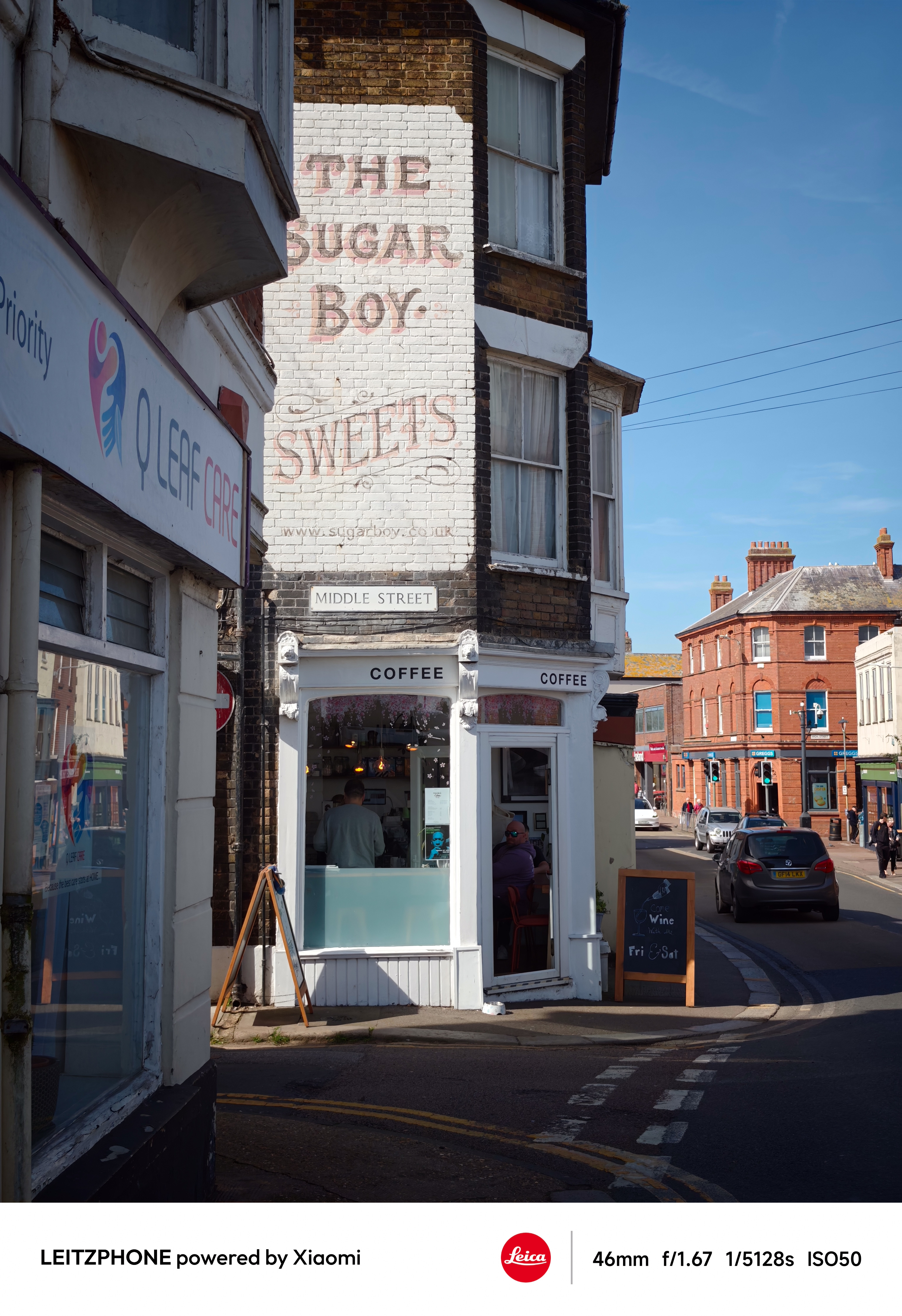 Corner coffee shop beneath a faded Sugar Boy Sweets wall sign