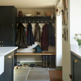 boot room with cupboard and wooden rack
